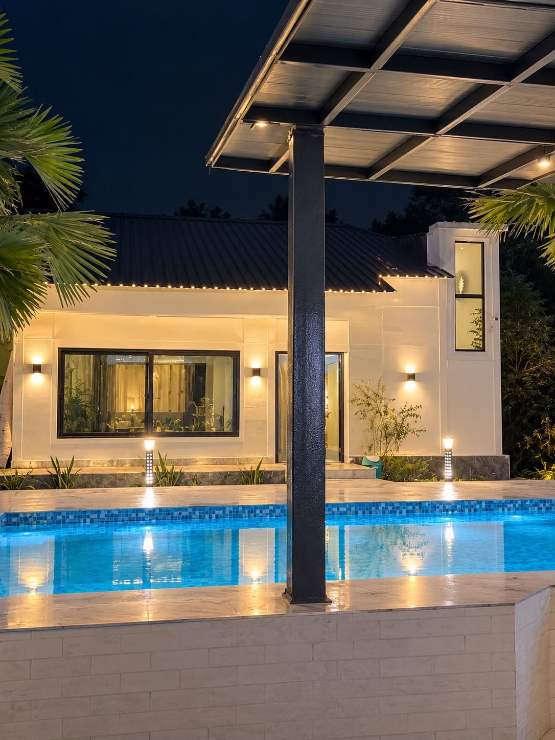 Night pool view with warm lights at The Cosmos Farm