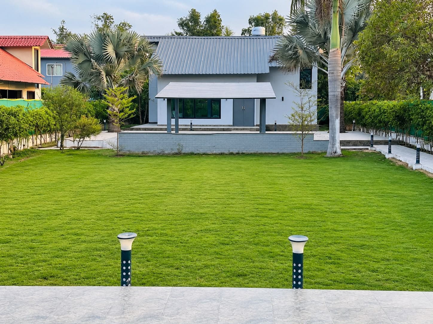 Outdoor lawn and farmhouse view at The Cosmos Farm